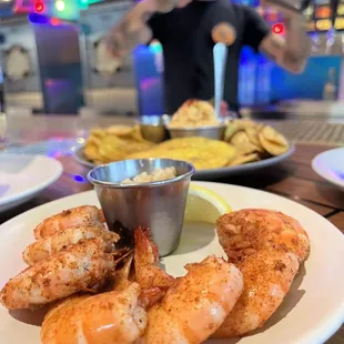 a plate of shrimp with dipping sauce