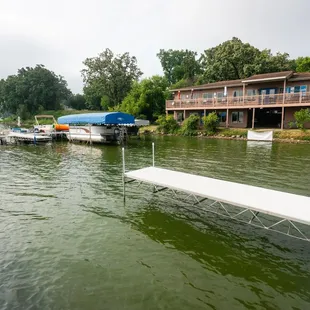 a dock with a boat and boat house