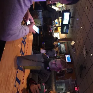 a man and a woman looking at their cell phones