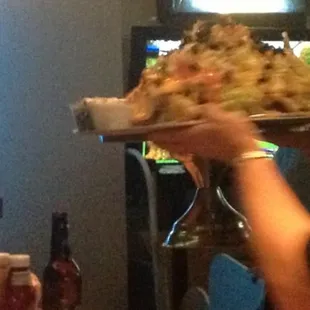 Action shot of the ginormous $13 nachos.