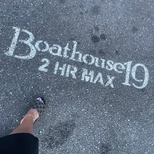 a person standing on a sidewalk with a chalk message