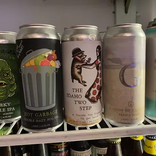 a row of beer cans on a shelf