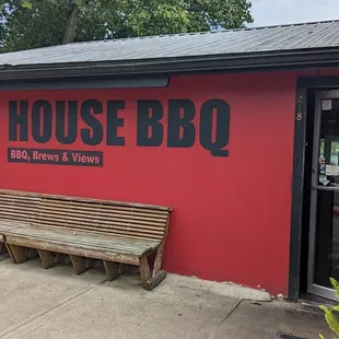 a bench in front of a red building