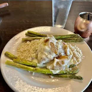 Stuffed Brie and apple chicken served on top of a bed of rice and grilled asparagus
