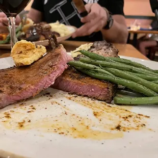 steak, green beans, and a glass of wine