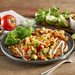 a plate of food with chicken and vegetables