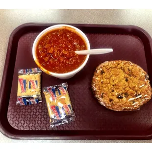 ows a bowl of chili and a sandwich