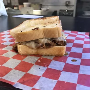 Bob's Reuben-pulled-pork w/ sweet sauce (or can choose) sautéed onions, Swiss cheese, coleslaw and spicy stone-ground mustard mayo.