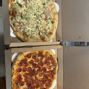 two pizzas in boxes