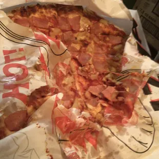 Pizzas arrived stacked on top of each other, the bottom one was a mess. Paper and toppings all stuck together.