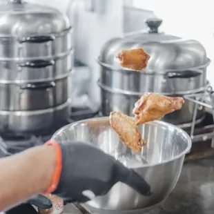 a person frying food in a bowl