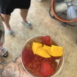 a person holding a bowl of fruit