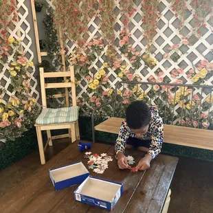 a woman sitting at a table with two boxes of tea