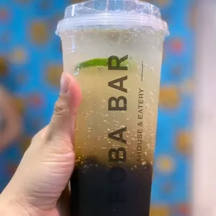 a person holding a cup of boba