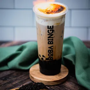a cup of coffee with a flame in the background