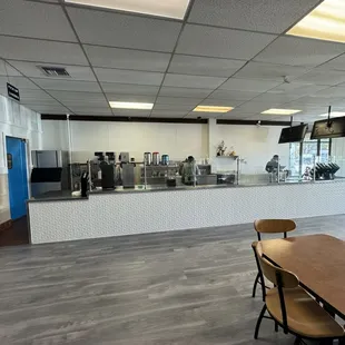 an empty cafeteria with tables and chairs