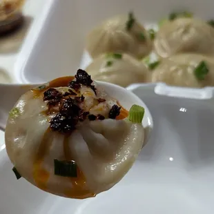 Soup dumplings / xiaolongbao with house made sauce and chili oil