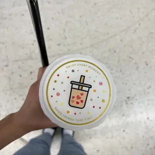 a person holding a cup of boba