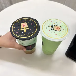 a person holding a cup of boba