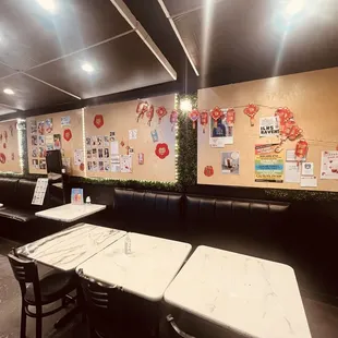 the interior of a restaurant with tables and chairs