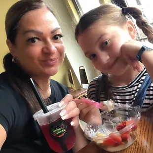 a woman and a young girl sitting at a table