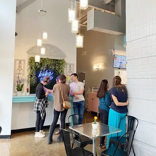 a group of people standing around a table