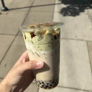Milk tea with boba and matcha foam