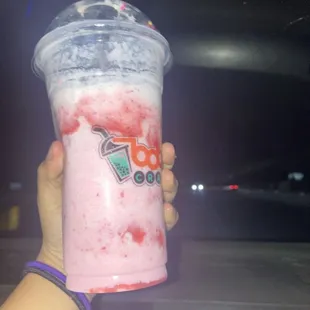 a hand holding a drink