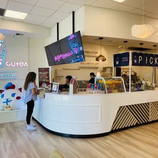 a woman standing in front of a counter