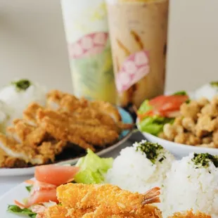 a plate of fried chicken, rice, and vegetables