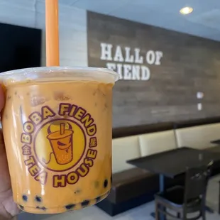a hand holding a cup of boba fiend tea