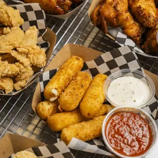 Mozzarella cheese sticks, chicken wings, sesame balls, and chicken bites