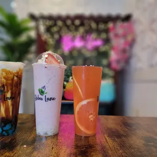 three different drinks on a table