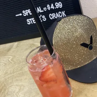 a strawberries drink and a baseball cap