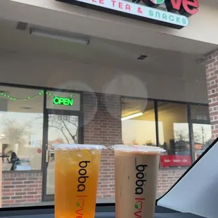 two drinks in front of a coffee shop