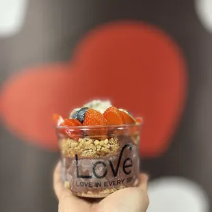 a hand holding a bowl of food