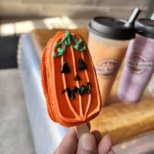 Chocolate macaroon shaped as a fun jack-o&apos;-lantern!