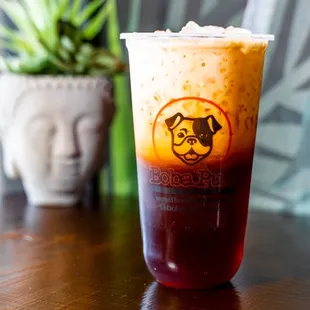  a boba drink with a face drawn on it