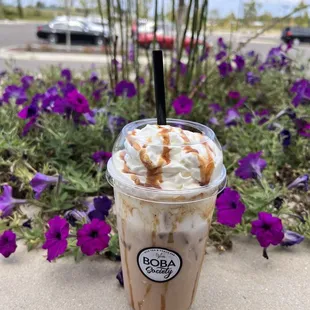 a cup of coffee with whipped cream and caramel