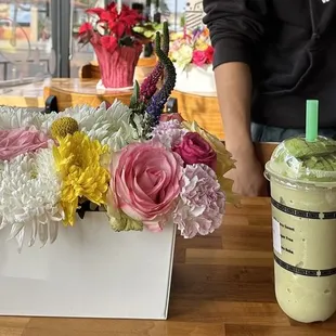 a man standing in front of a flower arrangement