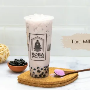a glass of boba milk tea and a wooden spoon