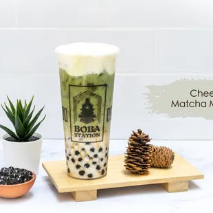 a cup of matcha milk tea and a pine cone