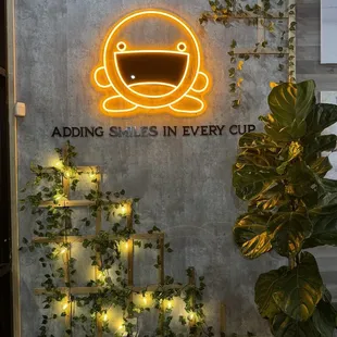 a sign that says adding smiles in every cup