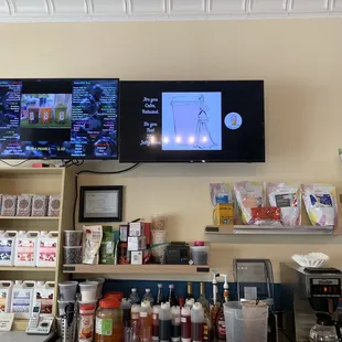 a coffee shop with two televisions on the wall