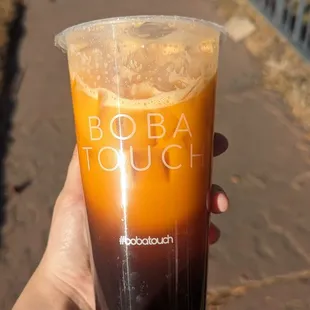 a hand holding a cold drink