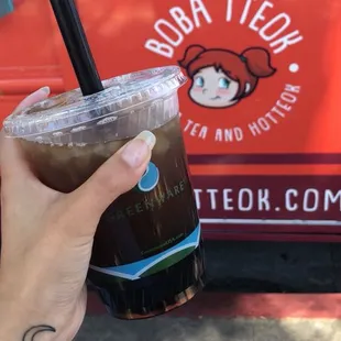a hand holding a cup of coffee