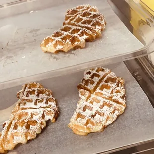 two waffles with powdered sugar on them