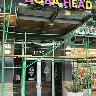 the entrance to a business with scaffolding