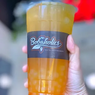 a person holding a cup of boba