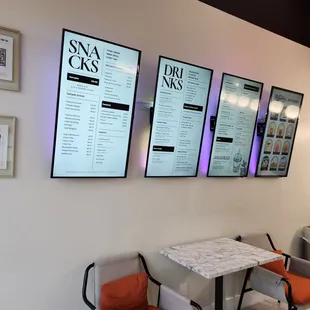 a wall of menus and chairs